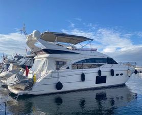 Princess 56 Luxury 2016 Princess 56 yacht docked in a marina under a clear blue sky.