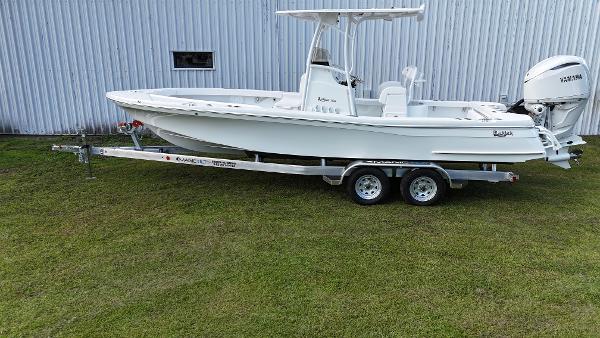 BlackJack 256 Coastal 2025 BlackJack 256 Coastal boat on trailer, parked on grass.