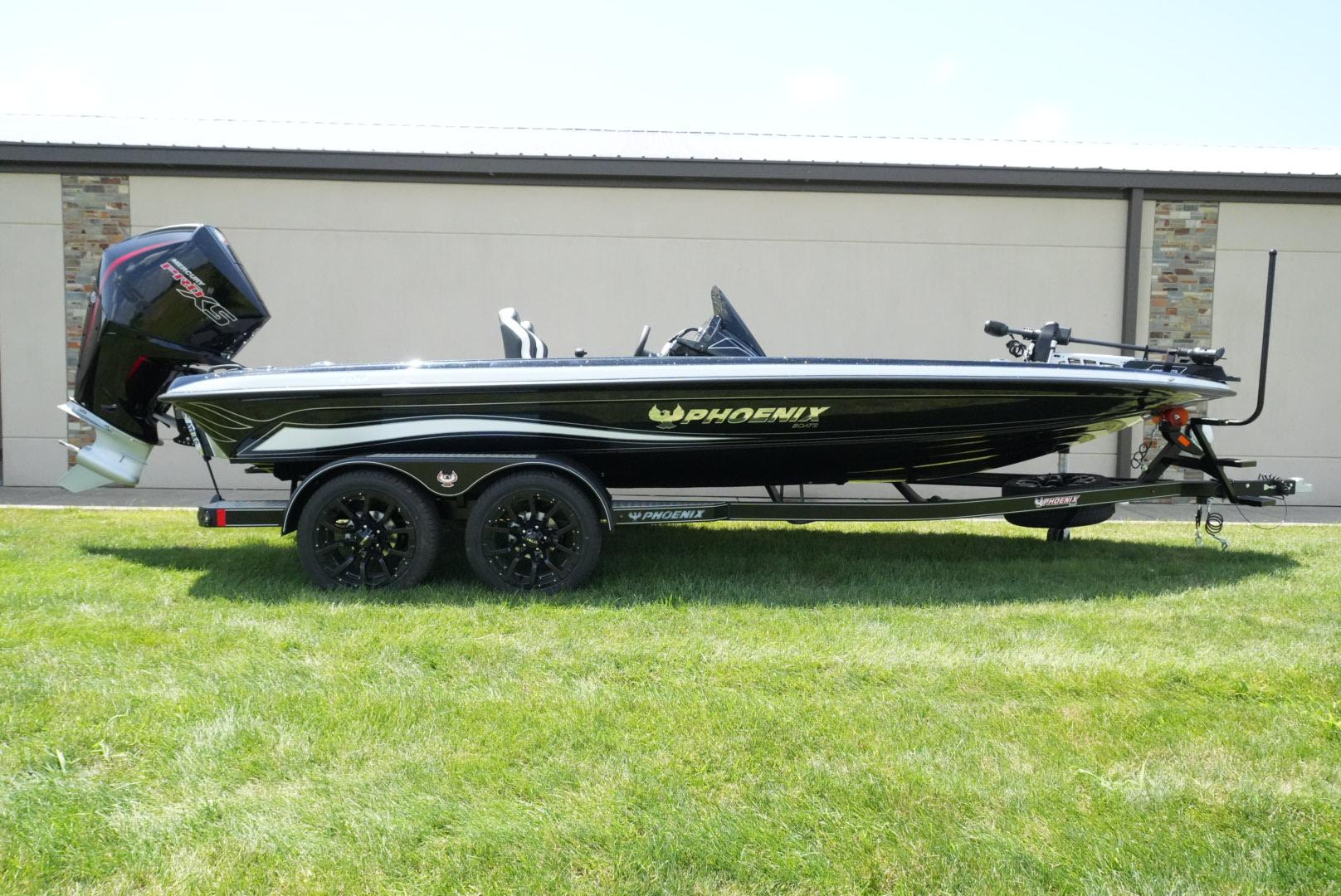 Phoenix 21 XE 2026 Phoenix 21 XE boat on trailer, black with green accents, parked on grass.