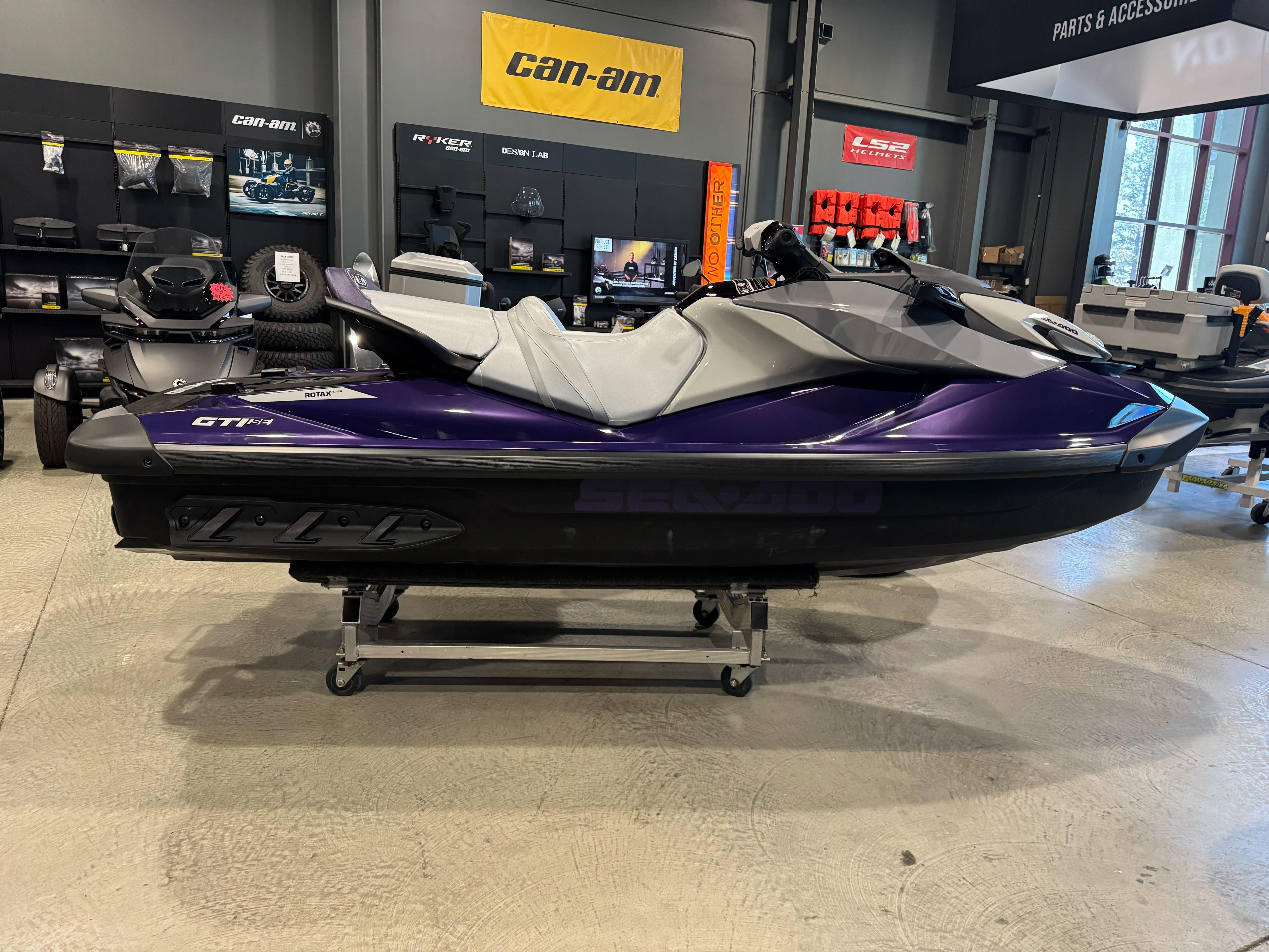 Sea-Doo GTI SE 130 2025 Sea-Doo GTI SE 130 jet ski in showroom, purple and gray design.
