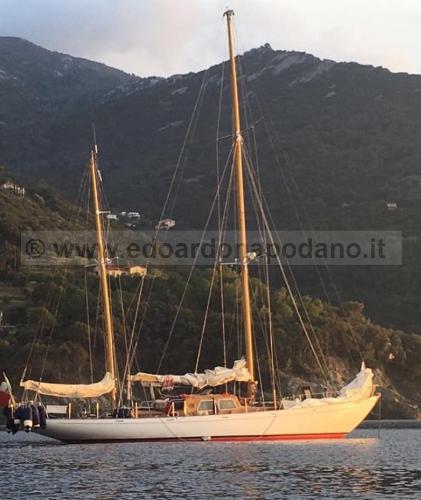 Sangermani Beltrami ketch 18 Sangermani Ketch 18, 1961 model, sailing near mountainous coastline at sunset.
