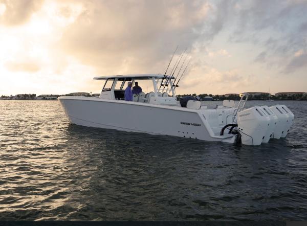 Twin Vee 400 GFX 2025 Twin Vee 400 GFX boat on calm water at sunset.
