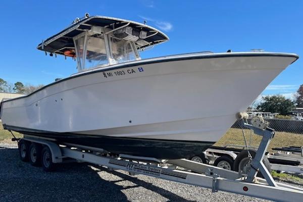 Grady-White 306 CC 2003 Grady-White 306 CC boat on trailer under clear blue sky.
