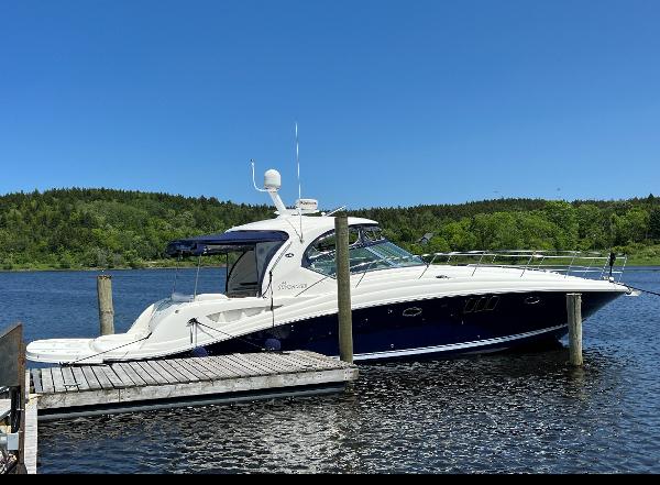 Sea Ray 44 Sundancer 2007 Sea Ray 44 Sundancer yacht docked on a sunny day with lush greenery.