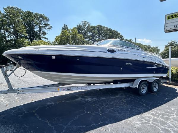 Sea Ray 240 Sundancer 2005 Sea Ray 240 SD boat on trailer, parked outdoors under clear sky.