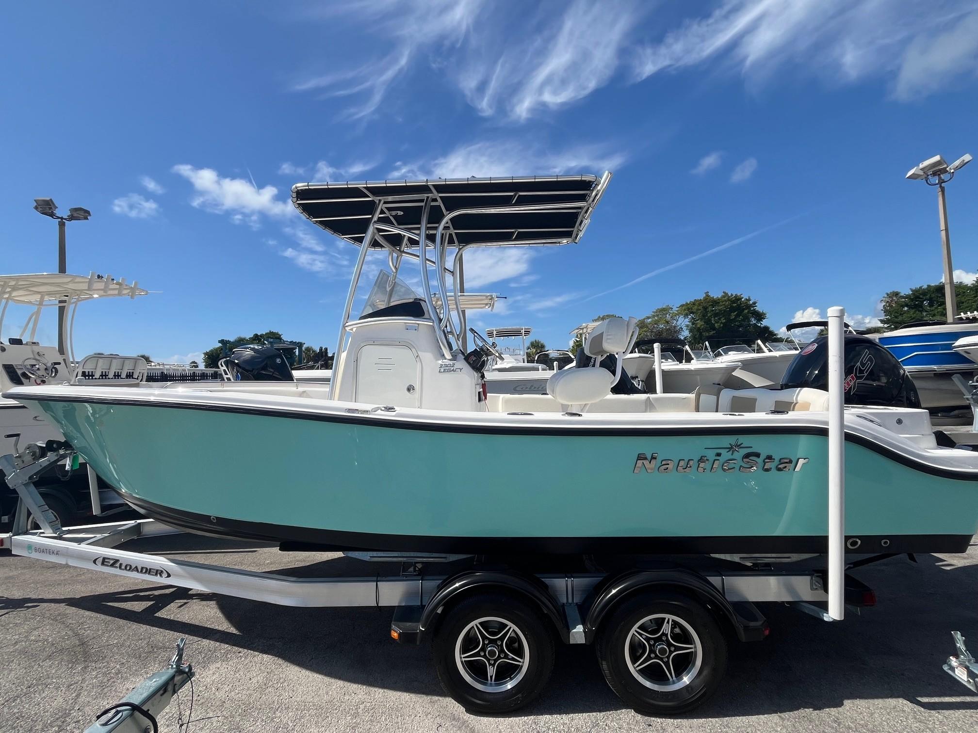 NauticStar 2302 Legacy 2022 NauticStar 2302 Legacy boat on trailer under clear blue sky.