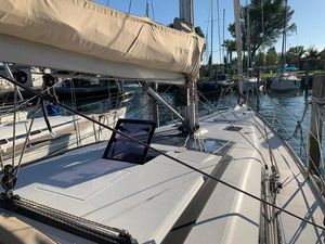 Dufour 410 Grand Large 2016 Dufour 410 Grand Large sailboat docked in a marina, showcasing deck and rigging.