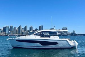 Sealine C335V 2025 Sealine C335V yacht on water with city skyline in background.