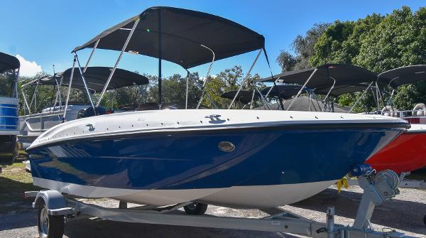 Bayliner E18 2025 Bayliner E18 boat with blue hull and canopy on trailer.