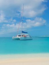 Leopard 48 Leopard 48 catamaran anchored in turquoise waters, under a clear blue sky.