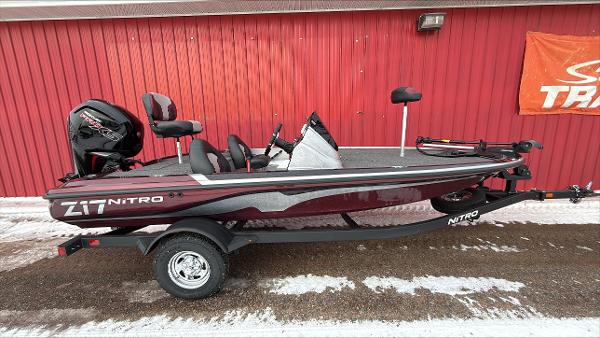 Nitro Z17 2025 Nitro Z17 boat with trailer, parked by a red wall, featuring sleek design and modern equipment.