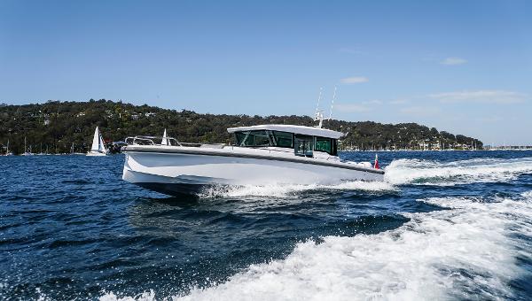 Axopar 37 XC Cross Cabin Wet Bar 2023 Axopar 37 XC Cross Cabin Wet Bar cruising on open water.