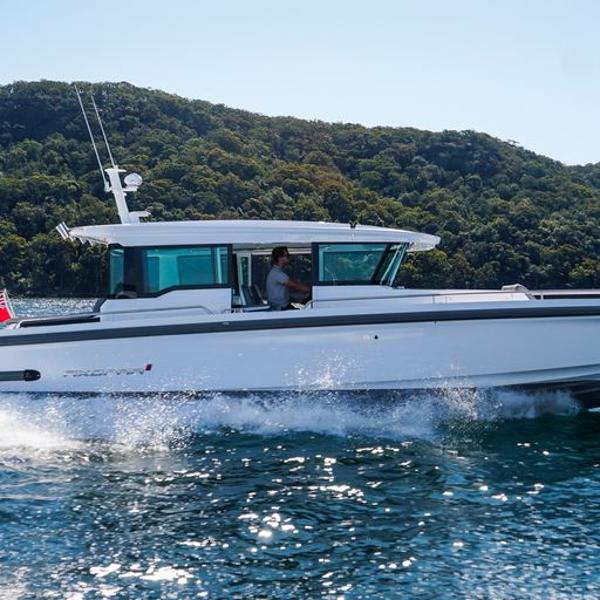 Axopar 37 XC Cross Cabin Wet Bar 2024 Axopar 37 XC Cross Cabin Wet Bar cruising on a scenic lake.
