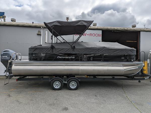 Berkshire 24 RFX CTS 2022 Berkshire 24 RFX CTS pontoon boat on a trailer outside a showroom.
