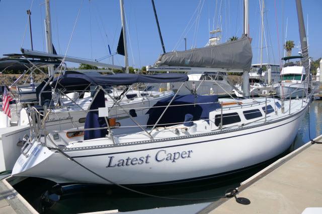 Catalina 38 1979 Catalina 38 sailboat named "Latest Caper" docked at a marina.