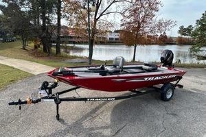 Tracker Panfish 17 2025 Tracker Panfish 17 boat on trailer by a scenic lake.