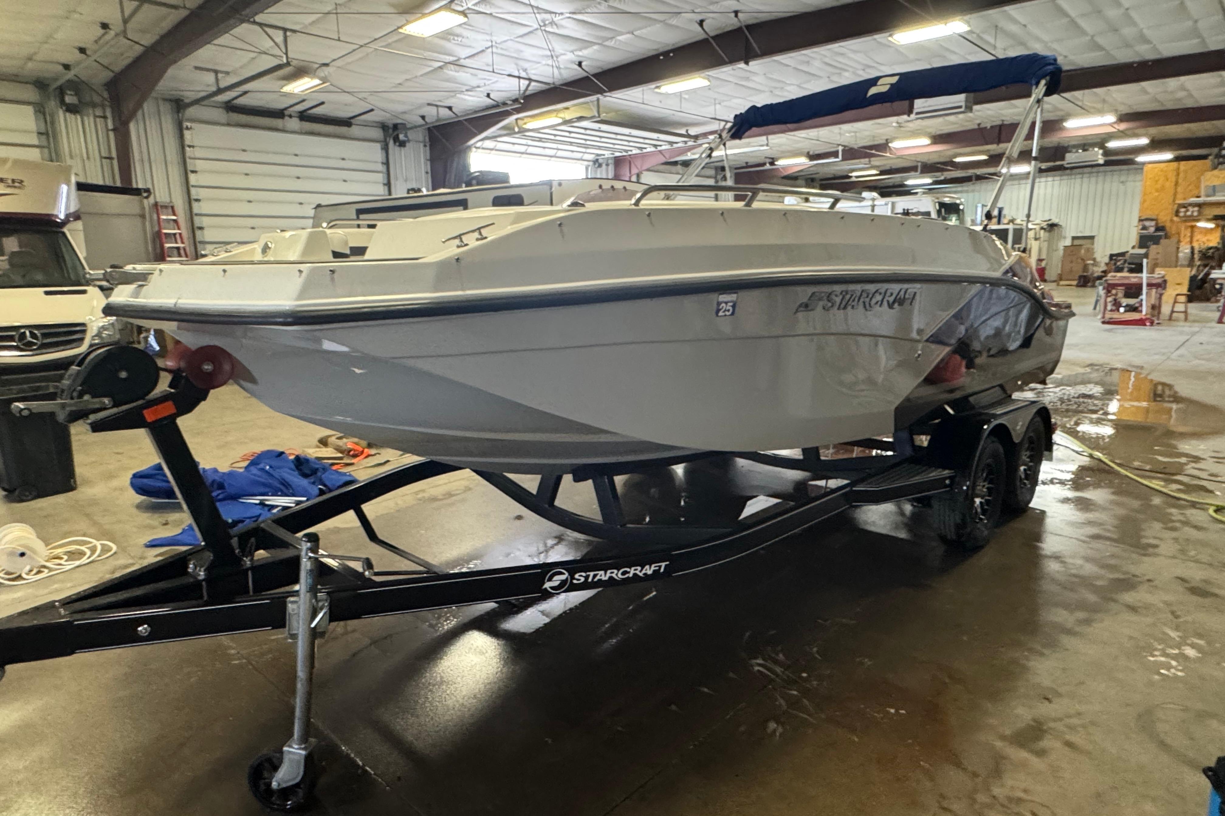 Starcraft SVX 191 OB 2023 Starcraft SVX 191 OB boat on trailer in indoor storage facility.