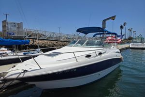 Chaparral Signature 240 2004 Chaparral Signature 240 boat docked with American flag, blue canopy, and clear sky.