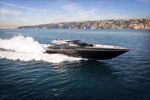 Baia ONE HUNDRED Luxury Baia ONE HUNDRED yacht cruising on the sea, 2010 model, with coastal city backdrop.