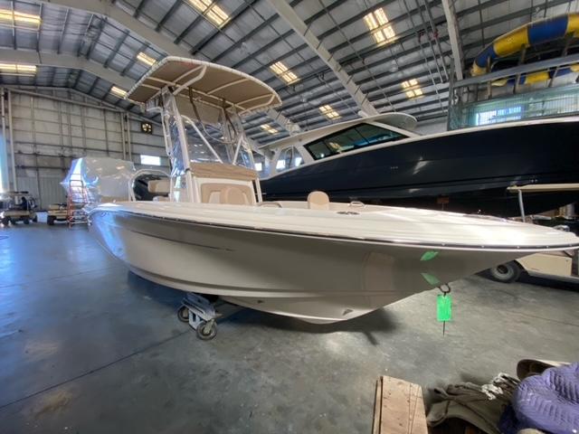 Scout 195 Sportfish 2024 Scout 195 Sportfish boat in a warehouse.