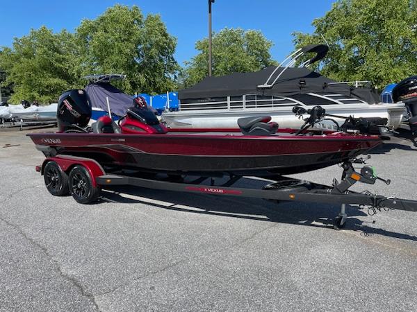 Vexus AVX2080 2024 Vexus AVX2080 boat on trailer, red and black, parked outdoors.