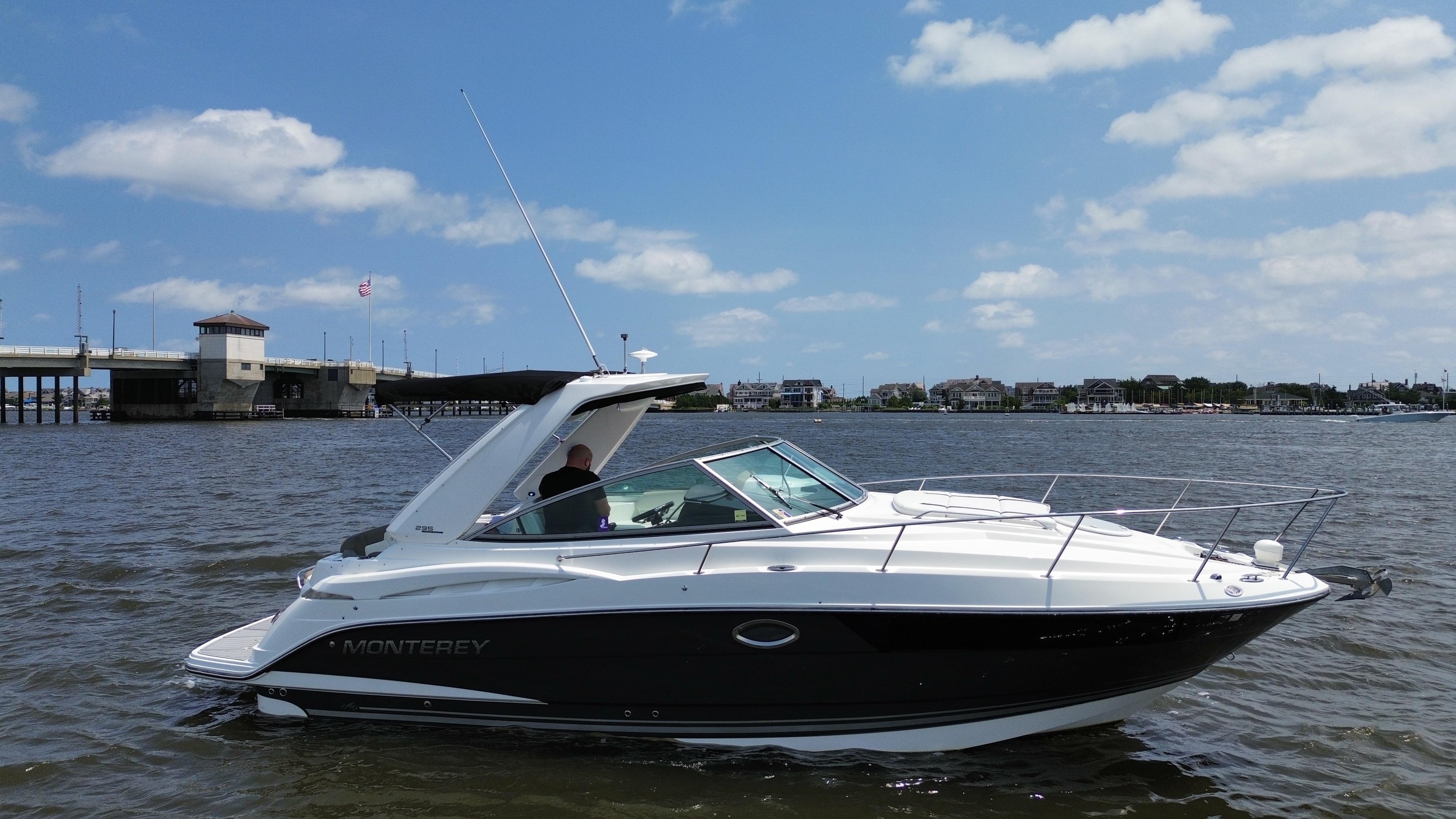 Monterey 295 Sport Yacht 2016 Monterey 295 Sport Yacht on water near a bridge under a blue sky.
