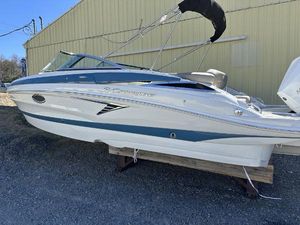 Crownline 250 XSS 2024 Crownline XSS Series 250 boat on display outside a yellow building.
