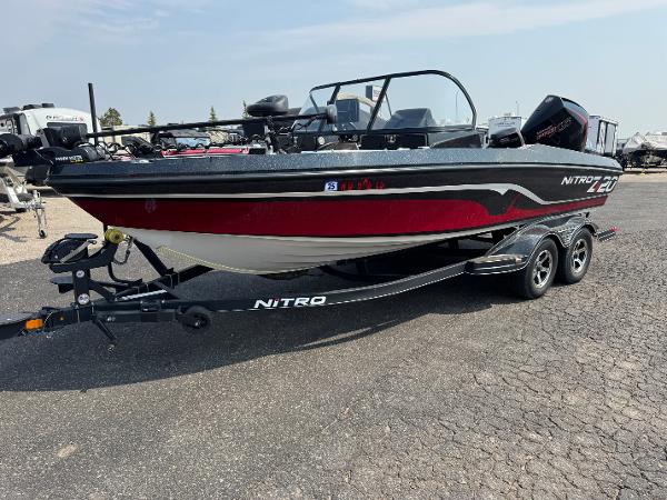 Nitro ZV20 2022 Nitro ZV20 boat on trailer, black and red design, parked outdoors.
