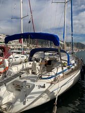 Bavaria 42 Cruiser Sailing yacht Bavaria 42, 2000 model, docked in a marina under a blue sky.