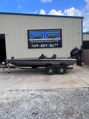 Falcon F205 2024 Falcon F205 boat on a trailer outside a marine products store.