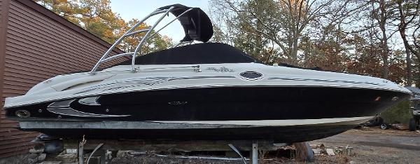 Sea Ray 270 Sundeck 2006 Sea Ray 270 Sundeck boat on a trailer, black and white design, outdoor setting.