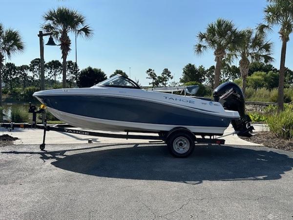 Tahoe 185 S 2024 Tahoe 185 S boat on trailer, parked near palm trees.