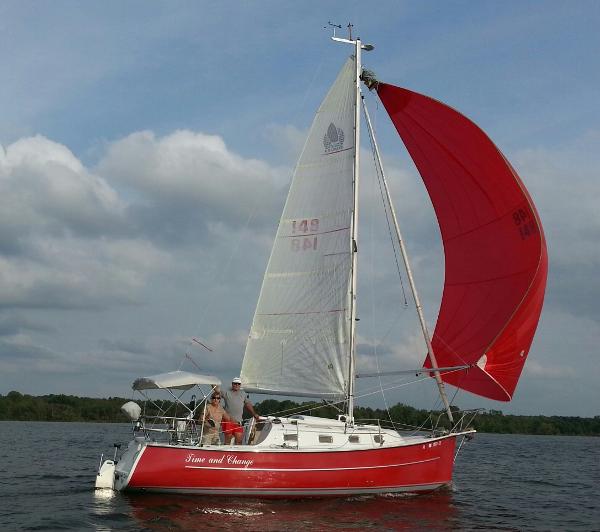 Hake / Seaward 26RK Red 2006 Hake Seaward 26RK sailboat with white sails on a calm lake.