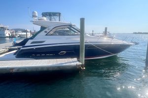 Regal 35 Sport Coupe 2017 Regal 35 Sport Coupe docked at marina under clear blue sky.
