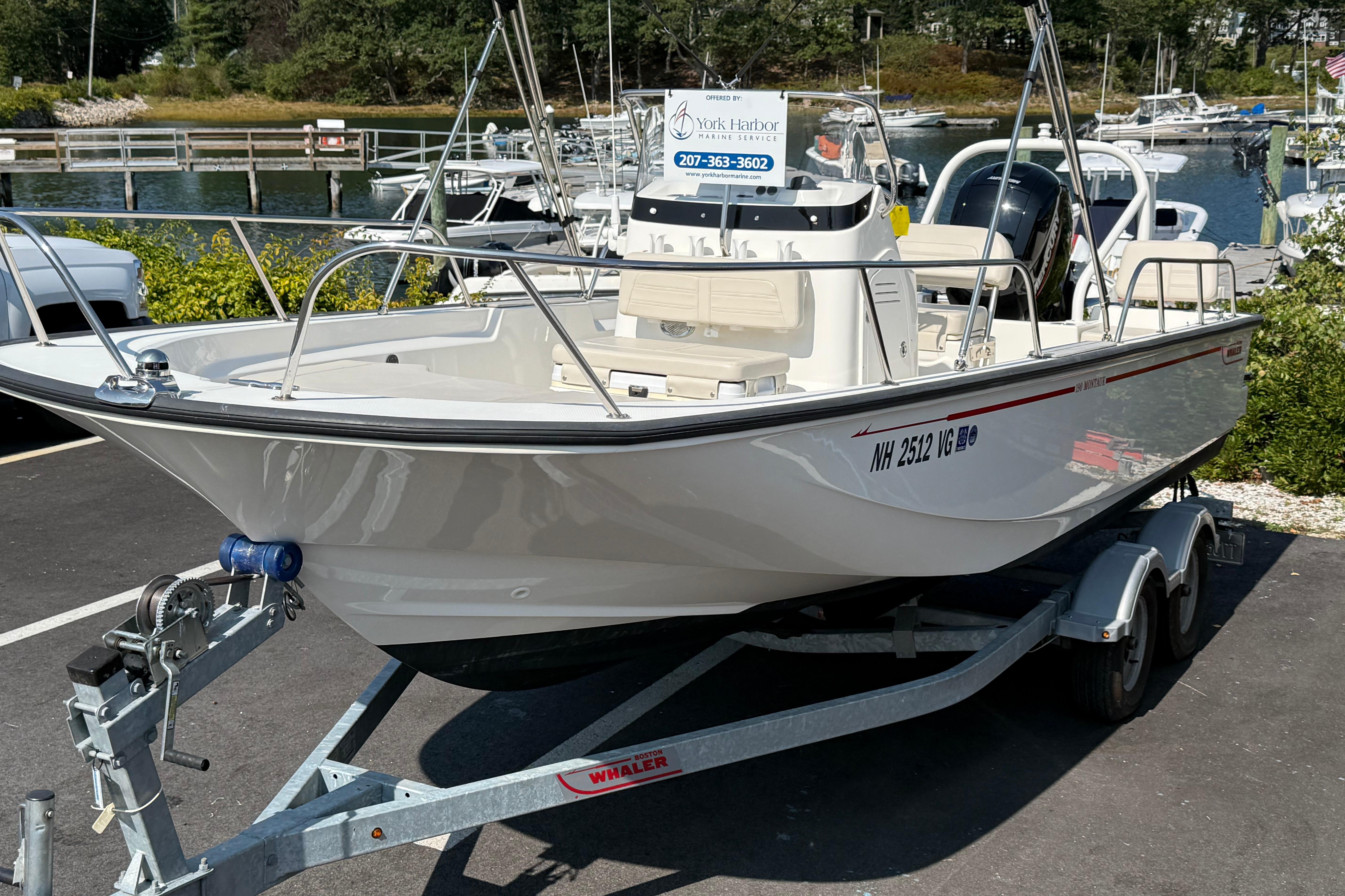 Boston Whaler 190 Montauk 2021 Boston Whaler 190 Montauk boat on trailer, parked near marina.