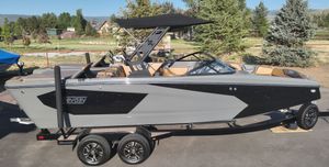 Heyday WTSurf 2022 Heyday WTSurf boat on trailer, parked outdoors with trees in the background.