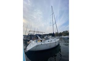 Dufour 36 Classic 2002 Dufour 36 Classic sailboat docked in a marina under a cloudy sky.