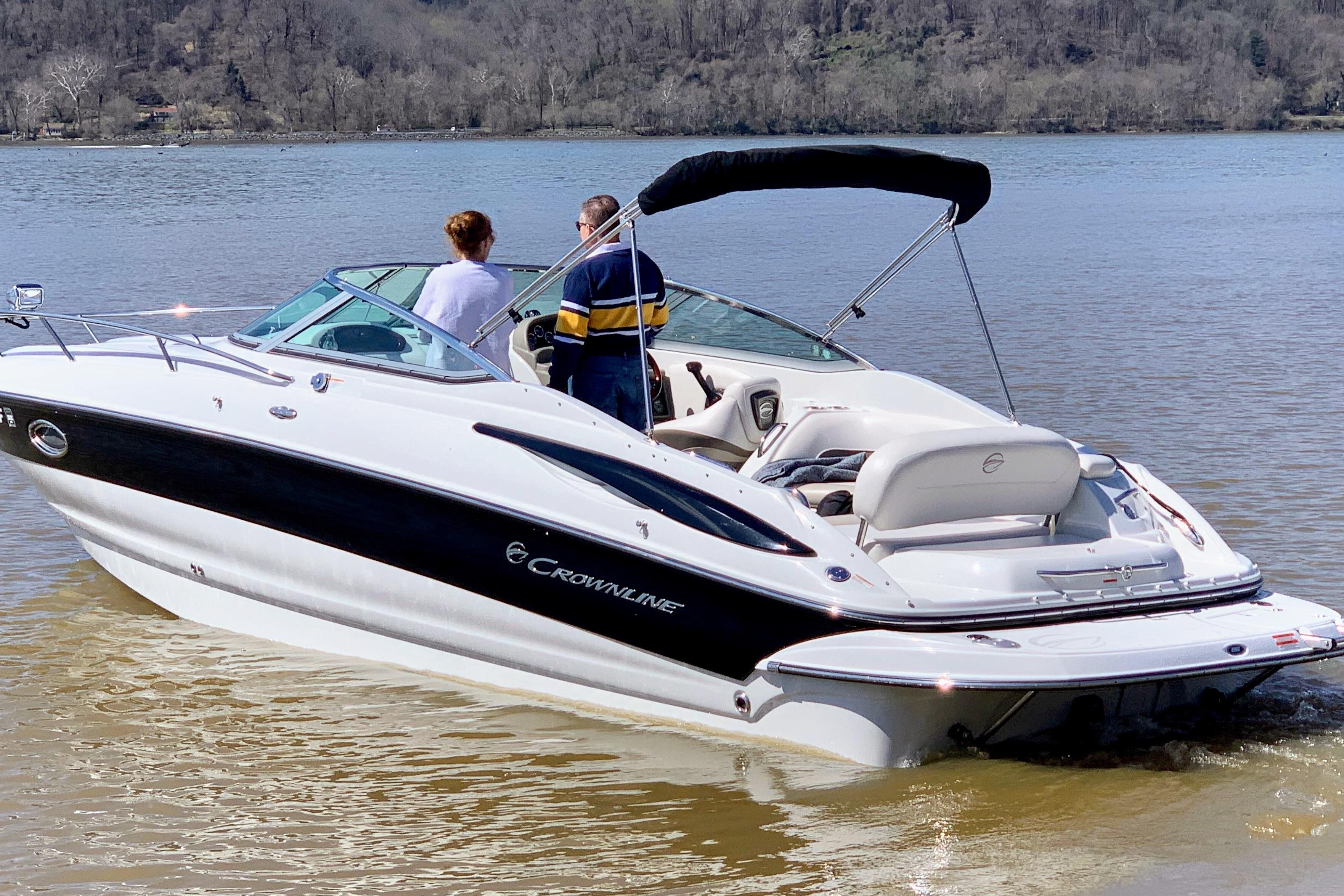 Crownline 286 SC 2011 Crownline 286 SC boat on a calm lake with two people onboard.