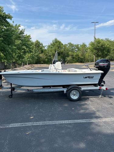 Mako Pro Skiff 13 CC 2025 Mako Pro Skiff 13 CC boat on trailer in parking lot.