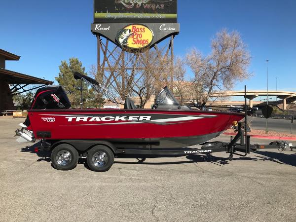 Tracker Targa V-18 Combo 2025 Tracker Targa V-18 Combo boat in red, parked near Bass Pro Shops.