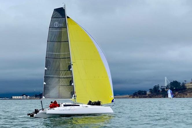 Corsair 760 Sailboat Corsair 760 Dash 2018 with yellow sail on calm water, overcast sky.