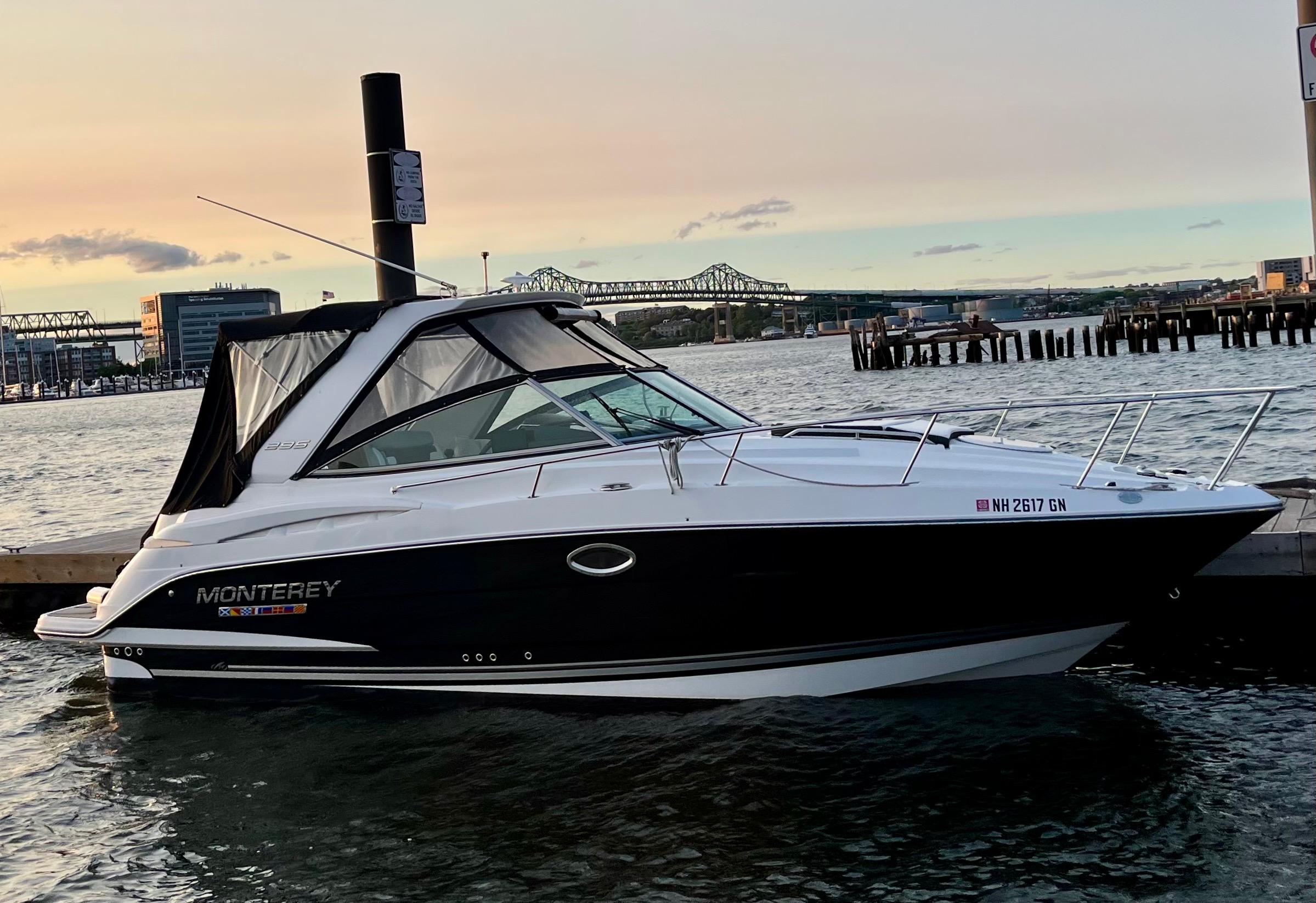 Monterey 295 Sport Yacht 2021 Monterey 295 Sport Yacht docked at sunset with cityscape background.