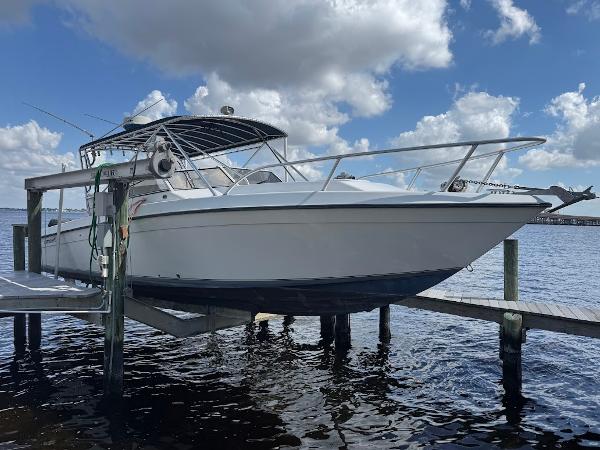 Contender 35 Side Console 2001 Contender 35 Side Console boat docked under a cloudy sky.