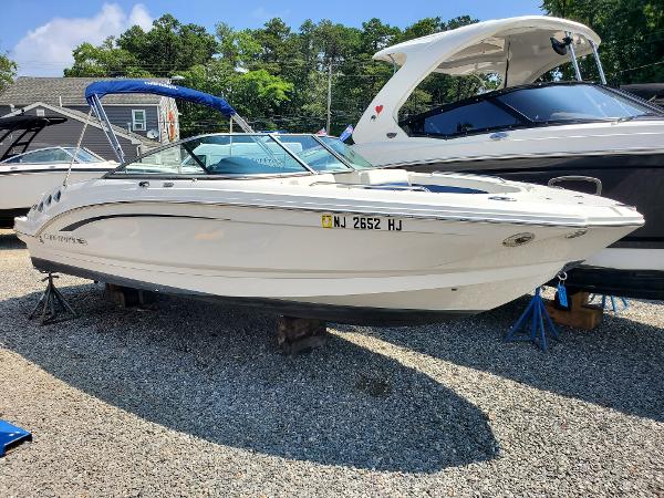 Chaparral 246 SSi 2015 Chaparral 246 SSi boat on display, white hull, parked on gravel lot.