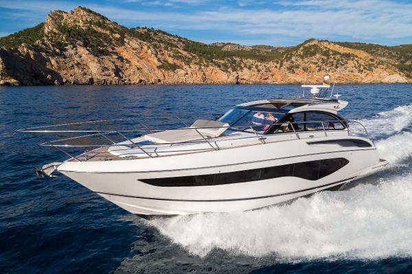 Princess V50 Open 2025 Princess V50 Open yacht cruising near rocky coastline.