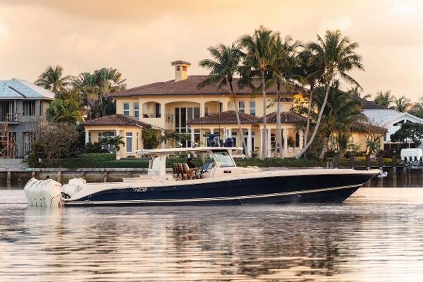 HCB 53 Sueños Luxury HCB 53 Sueños boat cruising near waterfront mansion, 2022 model.