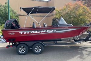 Tracker Targa V-19 Combo 2026 Tracker Targa V-19 Combo boat with canopy on trailer, parked outdoors.
