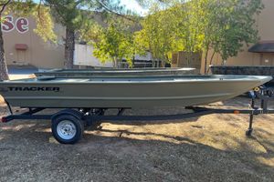 Tracker Grizzly 1648 Utility 2026 Tracker Grizzly 1648 Utility boat on trailer, parked outdoors.