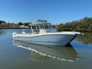World Cat 325 CC 2025 World Cat 325 CC boat on calm water, clear sky background.