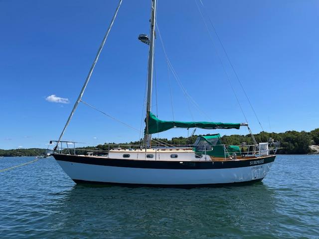 Morris Leigh 30 1979 Morris Leigh 30 sailboat on calm water under clear blue sky.